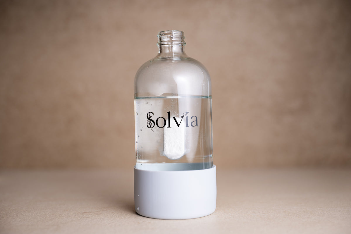 Solvia cleaning tablet dissolving in the reusable glass bottle